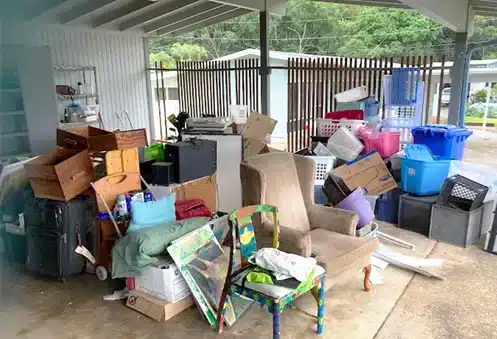Furniture, boxes, and storage bins gathered for foreclosure cleanout
