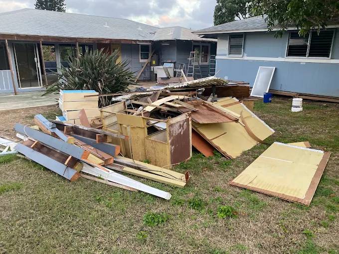 Construction and renovation debris piled outside a residential property
